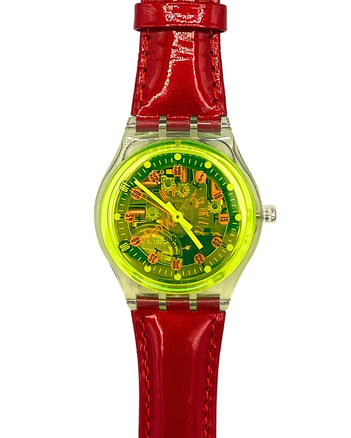 A Swatch wristwatch featuring a bright red textured strap, a clear case, and a vibrant neon yellow dial with orange details.