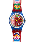A Swatch wristwatch featuring a bright red strap and case, decorated with colorful South American-style geometric and floral patterns. The watch face is red with multicolored hands and markers, and is framed by a blue bezel.
