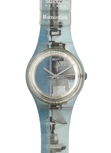 Swatch Access Rotterdam wristwatch with a translucent light blue strap featuring a black and white cityscape print, and a silver-toned circular case.