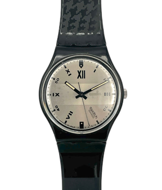 Black wristwatch with a patterned strap on a white background