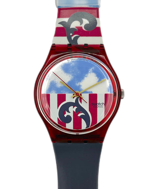 Swatch watch with a colorful strap and blue sky design on the face