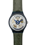 Watch with green strap and visible mechanism on a white background