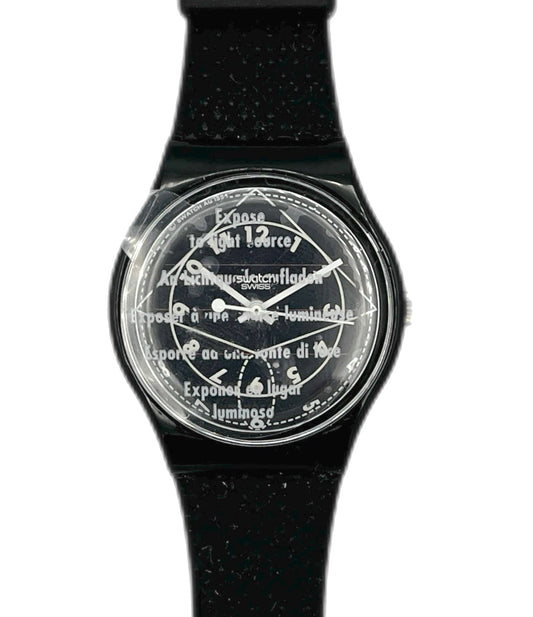 Black watch with a transparent face displaying text on a white background
