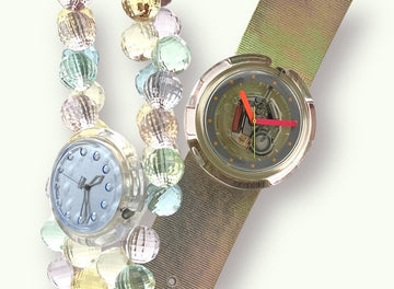 A new, unopened replacement band for a Pop Swatch watch, featuring a vibrant orange textile strap with a matching orange dial, packaged in a clear plastic case.