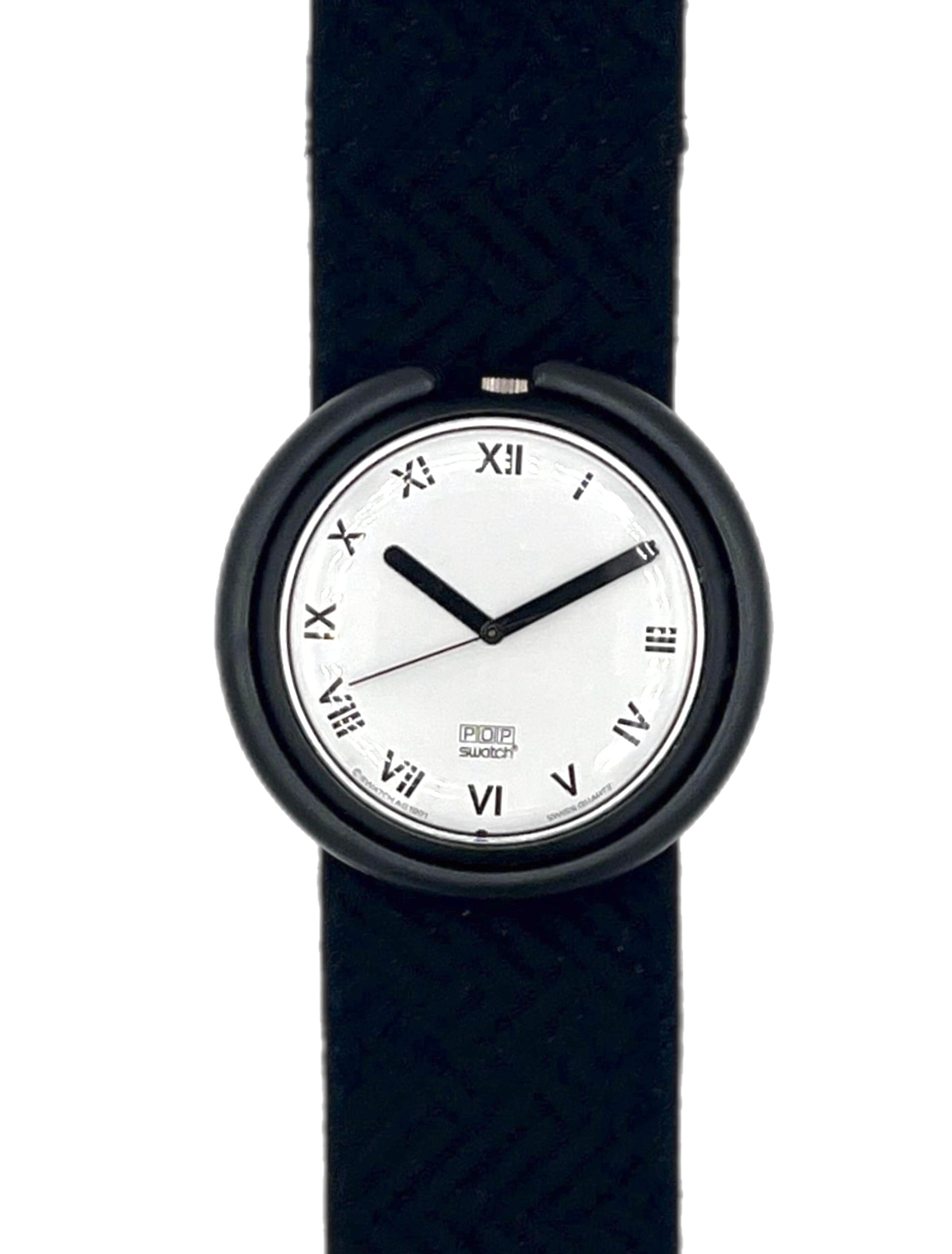 A minimalist wristwatch with a black round case, black hands, and black Roman numeral hour markers on a white dial, paired with a black woven-texture strap, shown against a plain white background.