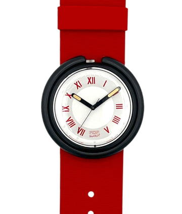 A minimalist wristwatch with a vibrant red silicone strap, a black bezel, and a white dial featuring red Roman numerals and gold-tone hands.