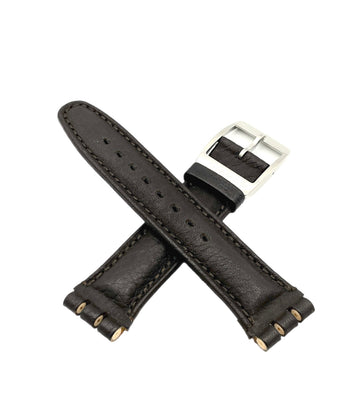 Brown leather watch strap with silver buckle on a white background