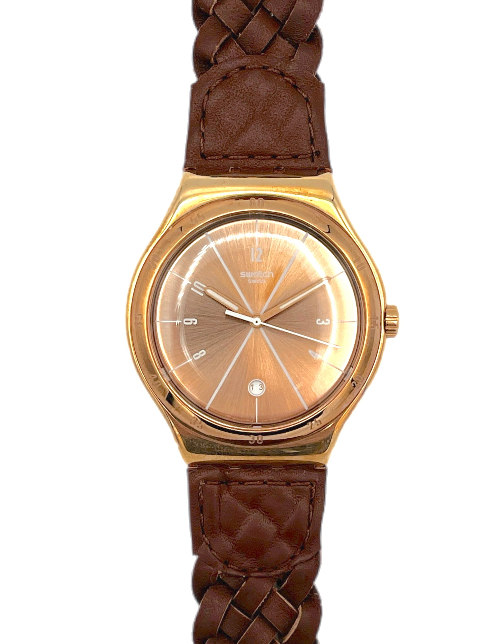 Gold watch with brown braided strap on a white background