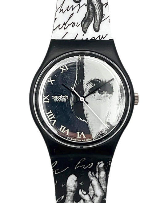 Swatch Swiss wristwatch with a black case and a split-face dial featuring a portrait split vertically. The strap is white and black with script and hand illustrations.
