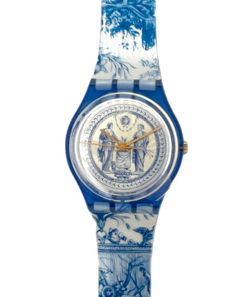 Watch with blue and white floral patterned strap on a white background