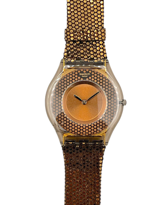 Gold watch with a textured band on a white background