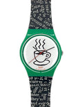 A Swatch wristwatch featuring a green case, a white dial with a black coffee cup illustration, and a black and white patterned strap.