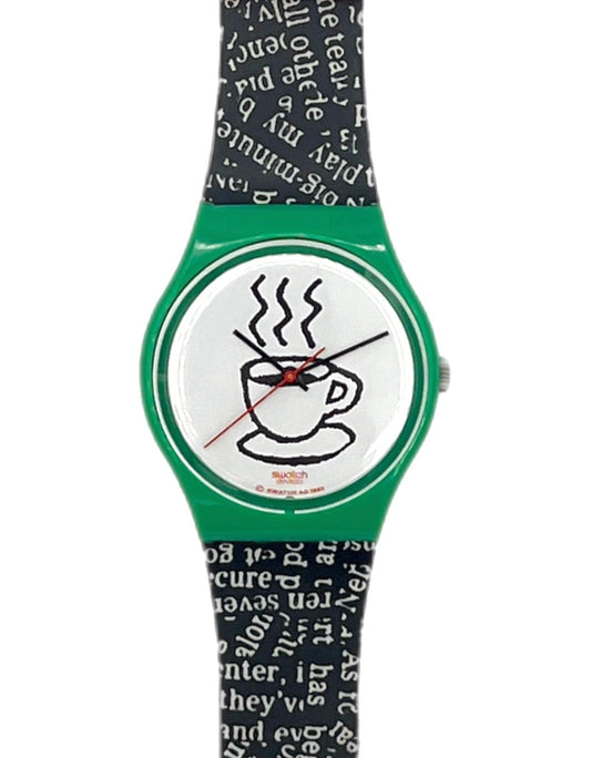 A Swatch wristwatch featuring a green case, a white dial with a black coffee cup illustration, and a black and white patterned strap.