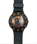 A Swatch wristwatch with a black textured strap, black bezel, and a black dial featuring bright orange and red accents.